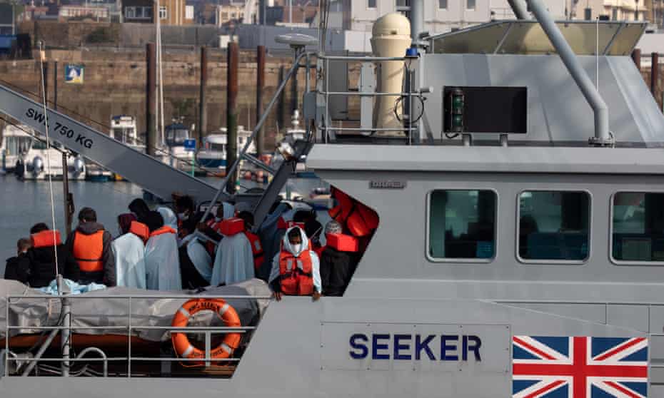 Migrants onboard HMC Seeker after being intercepted in the English Channel on 22 September.