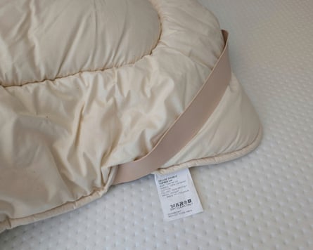 Woolroom mattress topper, showing under-mattress strap fastening.