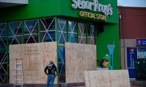 Workers protect a storefront with wood panels at the Mazatlán port in Sinaloa state, Mexico, on Monday before the arrival of Hurricane Willa.