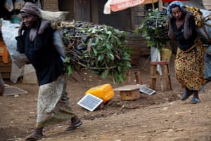 Women carry large sacks of illegally made charcoal that has been made with trees cut from the Kahuzi-Biéga park
