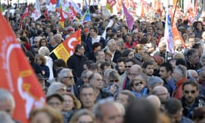People carry the flags of the French trade union CGT during a May Day rally in Bordeaux.