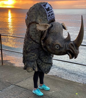 woman on seafront in rhino costume and trainers