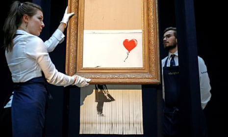 Sotheby’s staff reposition Banksy’s Love Is in the Bin, aka Girl with Balloon. 
