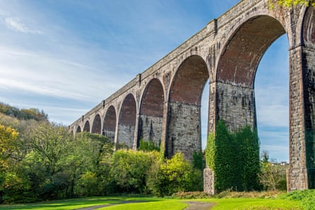A stone viaduct with a path weaving underneath.