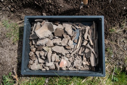 Container with pottery and bone