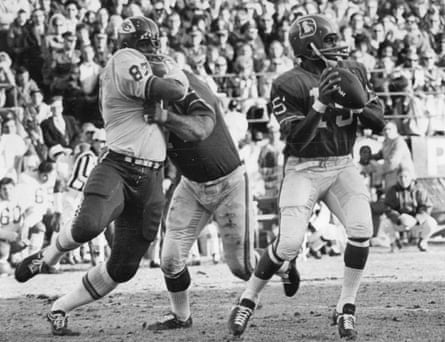 Denver Post ArchivesDEC 14 1968, DEC 15 1968 Denver Broncos (Action) Denver quarterback Marlin Briscoe is unaware that a battle is occurring behind him in the first quarter Saturday. Denver’s Sam Brunelli is shown holding Kansas City’s Aaron Brown while Briscoe prepares to let loose with a pass. Credit: Denver Post (Denver Post via Getty Images)