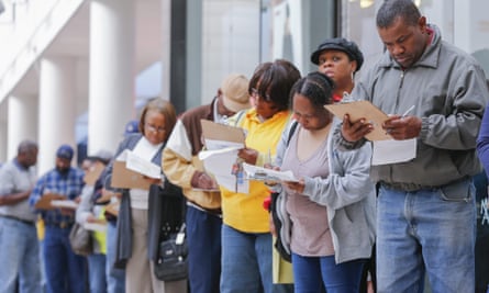 People fill out paperwork while waiting to cast their ballots in Georgia in 2014.