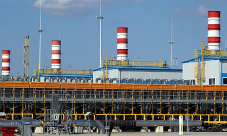 Gazprom’s Slavyanskaya compressor station, the starting point of the Nord Stream 2 pipeline. The image shows four red and white striped smokestacks above white buildings with blue roofs