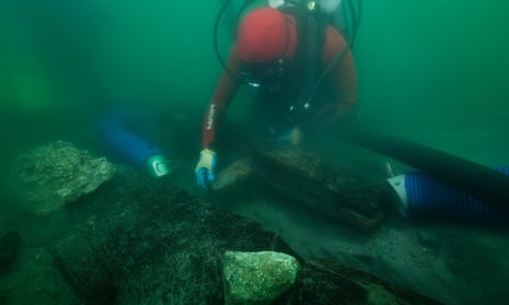 An archaeologist inspects the keel of a shipwreck discovered in the waters around the sunken port-city of Thonis-Heracleion.
