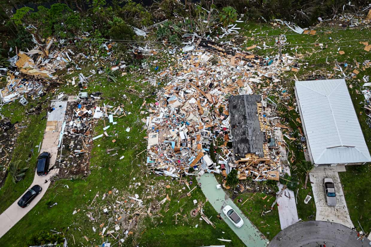 Aerial view of destroyed houses on residential street, debris filling the yards