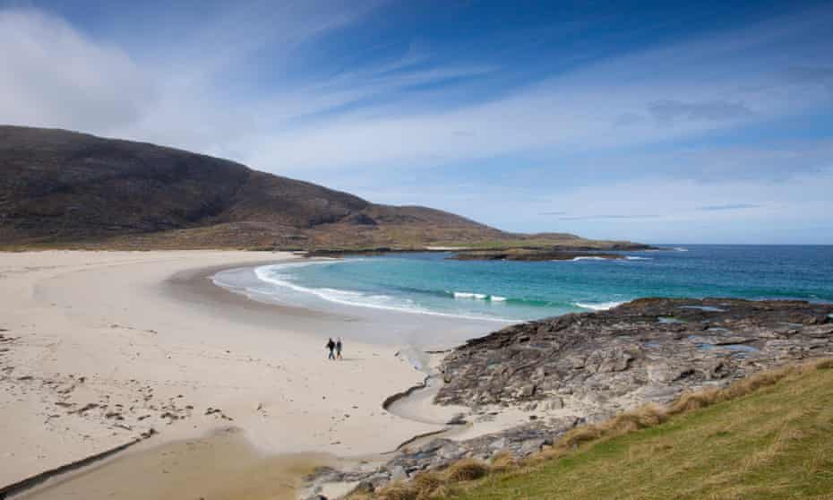 A couple walking on Tangasdale Beach, Barra
