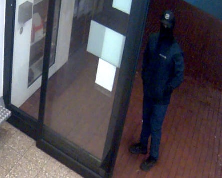 A suspect with a face covering