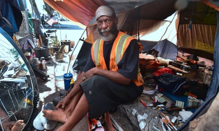 Homeless veteran Kendrick Bailey keeps cool inside his tent on a street corner near Skid Row, in downtown Los Angeles.