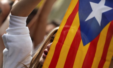 A demonstrator holds up a Catalan separatist flag in Barcelona