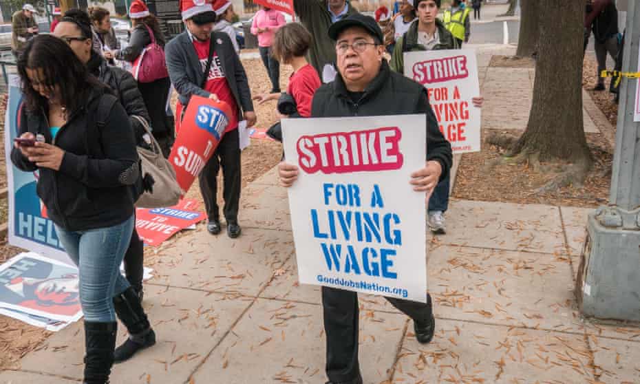 Workers march in favour of a minimum wage in Washington DC