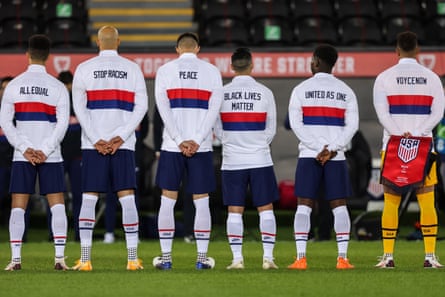 Players of United States of America line up for the national anthems with messages on the back of their jackets during the international friendly match between Wales and the USA at Liberty Stadium on November 12, 2020 in Swansea, Wales.