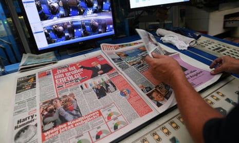 A worker checks a printed edition of Bild newspaper.