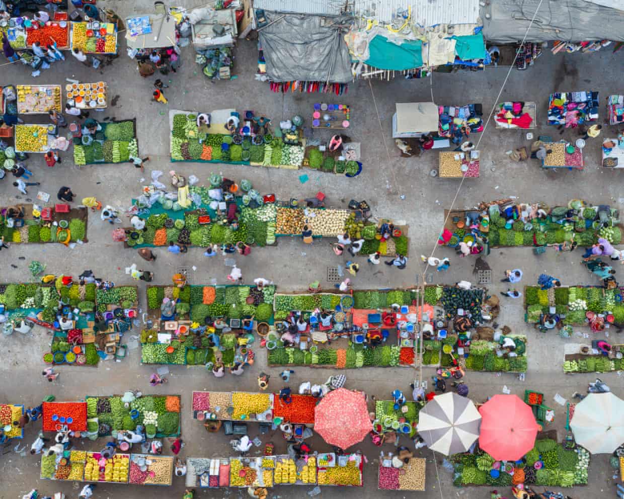 An aerial view captures vendors and customers at a busy vegetable market in Ahmedabad, India, on 25 April 2026.