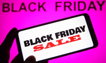 Black Friday sale words seen on a smartphone with Black Friday words in the background.