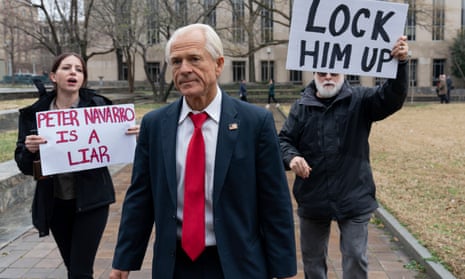 Peter Navarro is followed by demonstrators as he leaves the US federal courthouse in Washington in January.