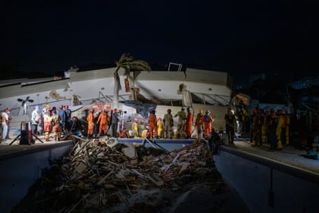 International rescue teams from Brazil, Ecuador and the UK work take part in an operation at a collapsed building in La Guaira.
