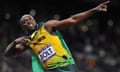 A man who is Usain Bolt celebrates and poses while wearing a Jamaican Olympics uniform and a tag that says 'Bolt'