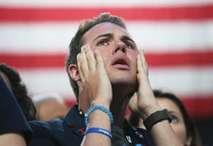 A Clinton supporter reacts with disbelief