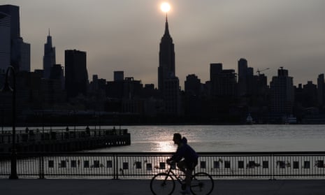 The sun rises behind the Empire State Building in New York City in a haze created by smoke from the west coast wildfires, 15 September 2020.