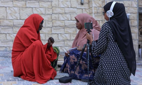 Two of Bilan's female journalists interview a woman on the streets of  Mogadishu, Somalia