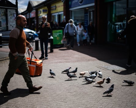 People and pigeons in the town centre of Ashton-in-Makerfield.
