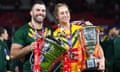 Australia's James Tedesco with the men's trophy and Kezie Apps with the women's trophy after their Rugby League World Cup finals in Manchester.