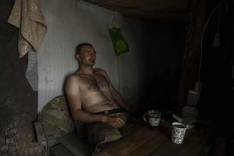 A Ukrainian serviceman takes a break after digging trenches near the frontline in the Donetsk region, eastern Ukraine, on Wednesday