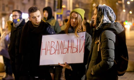 A woman holds up a placard reading ‘Navalny’ at a vigil in Chisinau, Moldova.