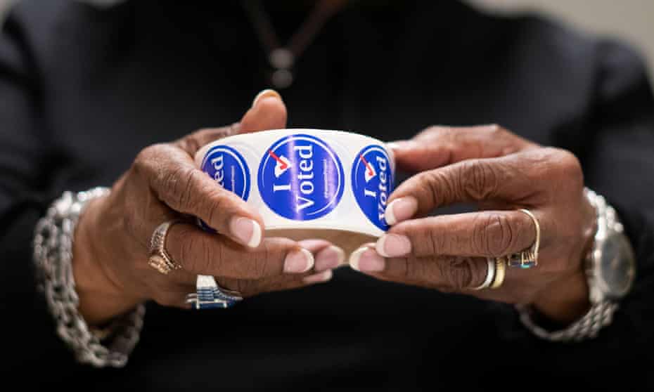 A poll manager unwinds “I Voted” stickers in anticipation of voters at a polling location in Spartanburg<br>A poll manager unwinds a roll of “I Voted” stickers in anticipation of voters on the day of the South Carolina Presidential Primary, at a polling location in Spartanburg, South Carolina, U.S., February 29, 2020,. REUTERS/Mark Makela