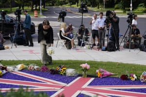 A mourner leaves flowers outside the British Embassy in Washington DC, US