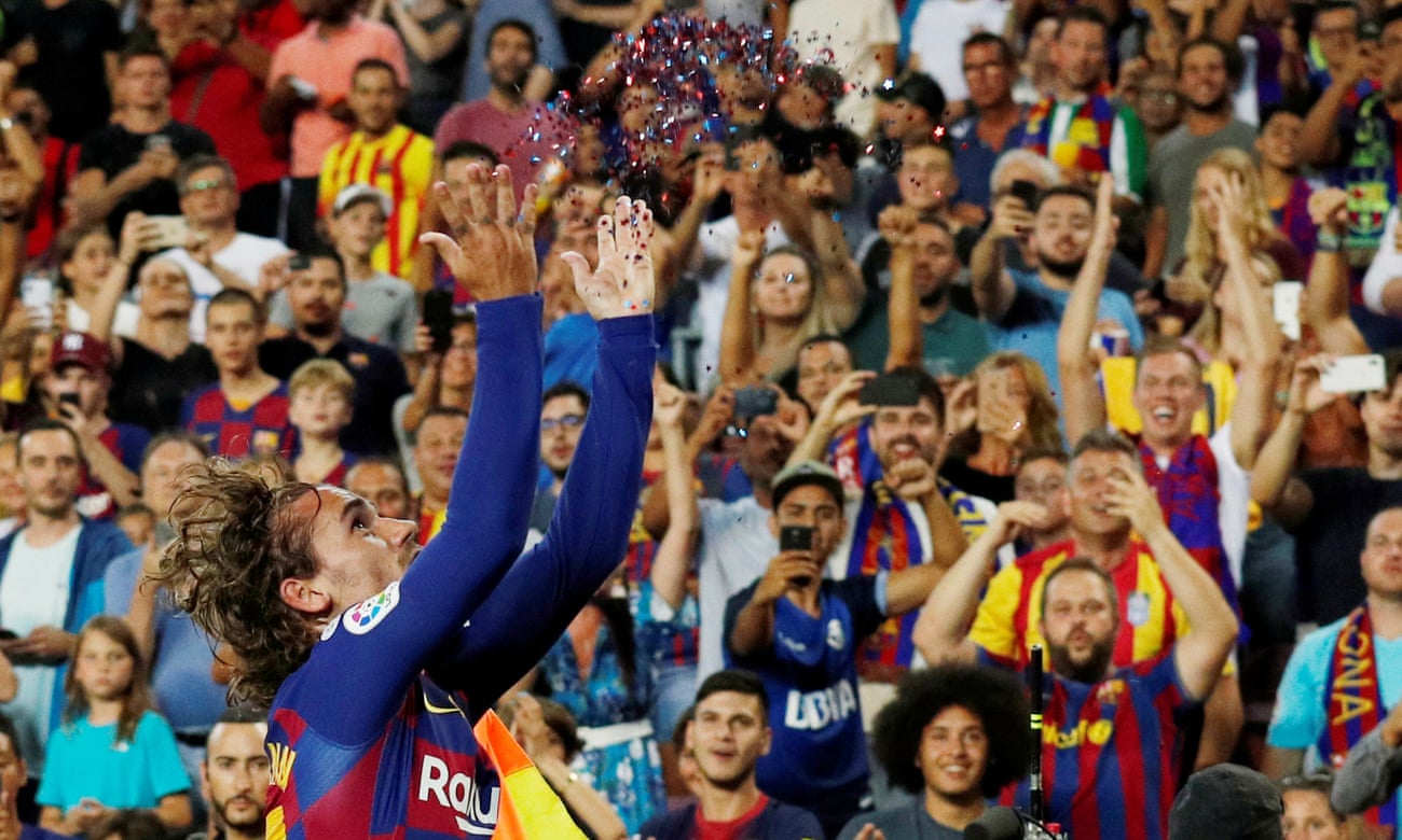 Barcelona’s Antoine Griezmann celebrates scoring their second goal with a container of confetti.