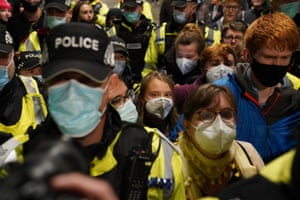 Police surround Greta Thunberg as she arrives at Glasgow Central station