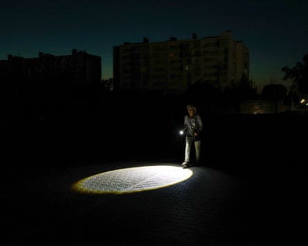 A pedestrian in Yevpatoriya, Crimea, uses a torch after local authorities limited electricity supplies.