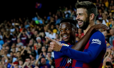 Barcelona’s Spanish defender Gerard Pique (right) is congratulated by teammate Ansu Fati after scoring.