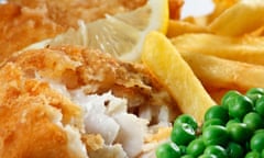 fish and chips, peas, lemon.<br>Close up of fish and chips with peas and a slice of lemon. A traditional British Seaside Dish