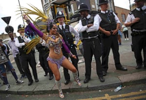 Police look as a performer dances
