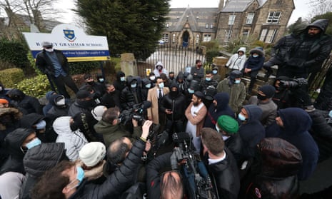 Protesters give a statement to the media outside Batley Grammar School in West Yorkshire in 2021, where a teacher had been suspended for reportedly showing a caricature of the Prophet Mohammed to pupils during a religious studies lesson. 