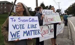 Demonstrators hold signs outside St Anselm College in Manchester, New Hampshire, where Susan Collins, one of the few possible Republican no votes on Kavanaugh, was scheduled to speak.