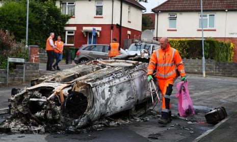 The remains of a car set alight during the riot  in Ely, Cardiff, on Monday night
