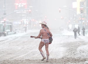 New York City, USThe Naked Cowboy performer crosses Seventh Avenue as snow falls in Times Square. New York City and much of the Northeast is being hit by a major winter storm that is expected to bring as much as two feet of snow when done sometime Tuesday morning. Schools, public transportation and vaccine centres across the region are being impacted by the storm