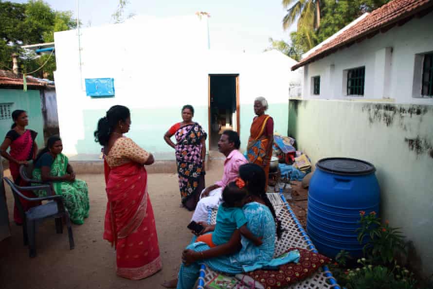 Thivya Rakini, president of the Tamil Nadu Textile and Common Labour Union speaks with Kathiravel’s family at their home.