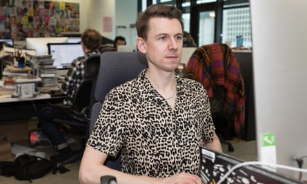 Tim Jonze in a New Look shirt at his desk in the Guardian office.