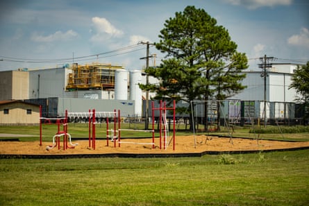 The Tyson Foods Green Forest processing plant is seen from a playground.