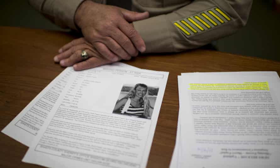 sheriff’s hands behind document showing Papini