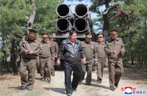 Kim Jong-un surrounded by military figures while inspecting military hardware